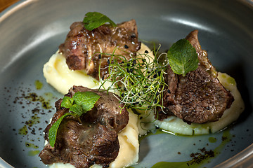 Image showing Grilled steak with vegetables puree on plate.