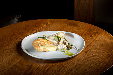 Image showing closeup of a plate with a typical tortilla de patatas, spanish omelet, on a set table