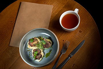 Image showing Grilled steak with vegetables puree on plate.