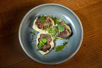 Image showing Grilled steak with vegetables puree on plate.