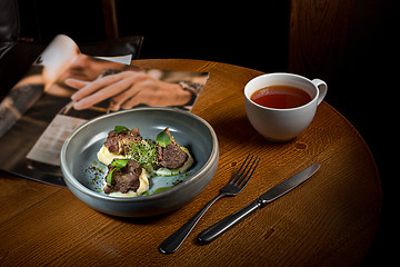 Image showing Grilled steak with vegetables puree on plate.