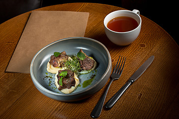 Image showing Grilled steak with vegetables puree on plate.