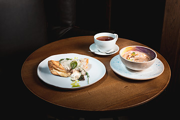 Image showing closeup of a plate with a typical tortilla de patatas, spanish omelet, on a set table