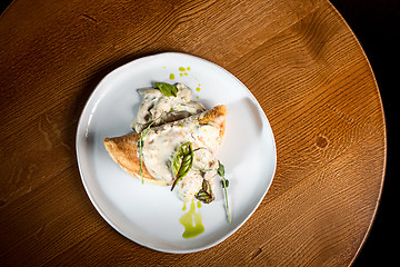 Image showing closeup of a plate with a typical tortilla de patatas, spanish omelet, on a set table