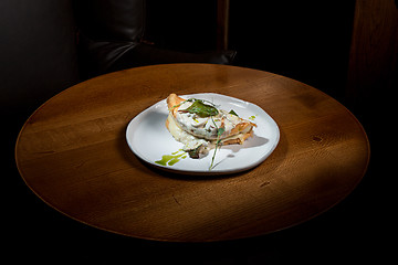 Image showing closeup of a plate with a typical tortilla de patatas, spanish omelet, on a set table