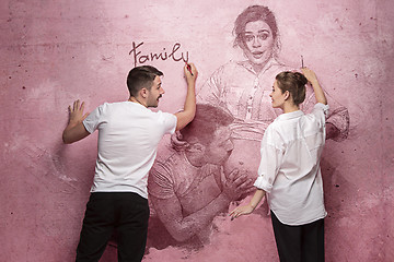 Image showing The collage about couple writing something on a pink wall