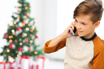 Image showing boy calling on smartphone at home at christmas