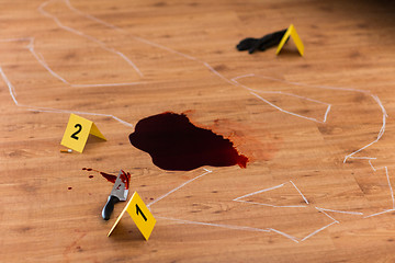 Image showing chalk outline and knife in blood at crime scene