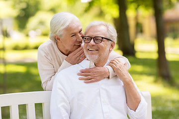 Image showing happy senior couple sitting on bench at park