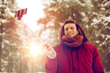 Image showing happy man taking selfie by smartphone in winter