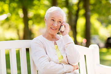 Image showing happy senior woman calling on smartphone in summer