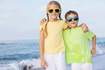 Image showing Two happy children playing on the beach at the day time