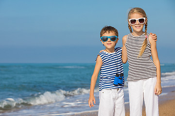 Image showing Two happy children playing on the beach at the day time