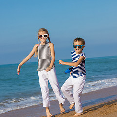 Image showing Two happy children playing on the beach at the day time