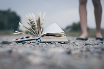 Image showing open book lying on the road.