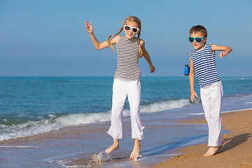 Image showing Two happy children playing on the beach at the day time