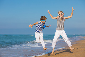 Image showing Two happy children playing on the beach at the day time