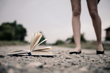 Image showing open book lying on the road. 