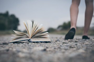 Image showing open book lying on the road