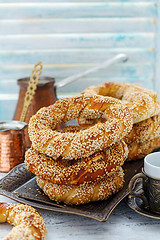 Image showing Turkish Simit bagels with sesame seeds on a bronze tray.