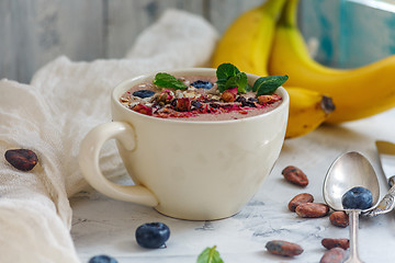 Image showing Smoothie bowl with chocolate, cocoa beans and blueberries.