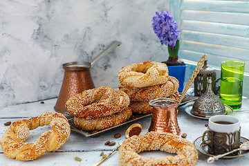 Image showing Tasty bagels with sesame seeds and pots of coffee.