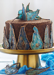 Image showing Cake with decor of blue dried pears.