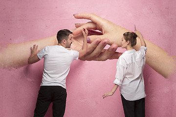 Image showing The collage about couple writing something on a pink wall