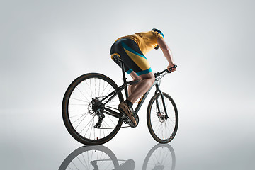 Image showing The bicyclist on gray, studio shot.