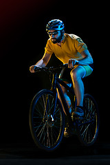 Image showing The bicyclist on black, studio shot.