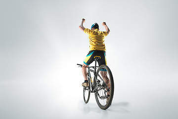 Image showing The bicyclist on gray, studio shot.