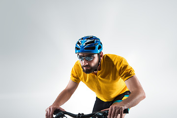 Image showing The bicyclist on gray, studio shot.