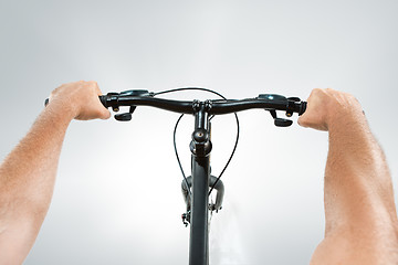 Image showing The bicyclist on gray, studio shot.