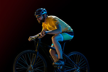 Image showing The bicyclist on black, studio shot.