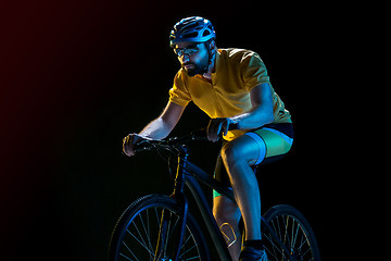 Image showing The bicyclist on black, studio shot.