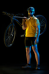 Image showing The bicyclist on black, studio shot.