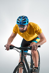 Image showing The bicyclist on gray, studio shot.