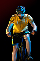 Image showing The bicyclist on black, studio shot.