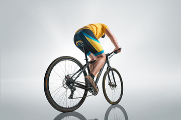 Image showing The bicyclist on gray, studio shot.