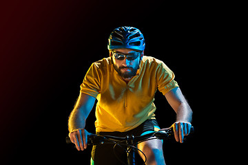 Image showing The bicyclist on black, studio shot.