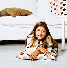 Image showing little cute brunette girl at home interior happy smiling close u