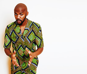 Image showing portrait of young handsome african man wearing bright green national costume smiling gesturing, entertainment stuff 