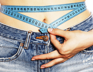 Image showing girls stomach measuring with tape twice isolated close up