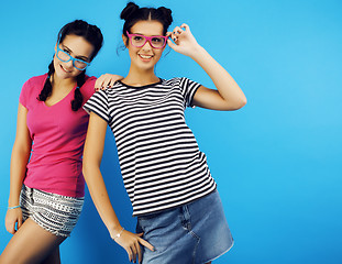 Image showing best friends teenage school girls together having fun, posing emotional on blue background, besties happy smiling, lifestyle people concept 