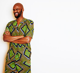 Image showing portrait of young handsome african man wearing bright green national costume smiling gesturing, entertainment stuff 