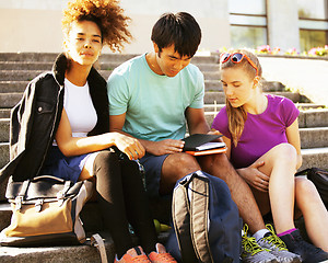 Image showing cute group of teenages at the building of university with books huggings, diversity nations