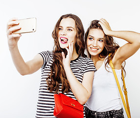 Image showing best friends teenage girls together having fun, posing emotional on white background, besties happy smiling, lifestyle people concept close up. making selfie