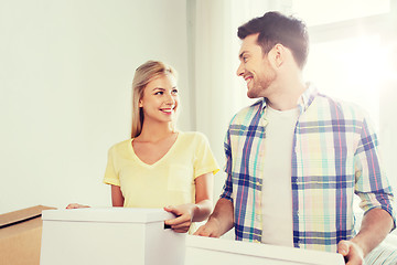 Image showing smiling couple with big boxes moving to new home