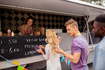 Image showing happy customers queue at food truck