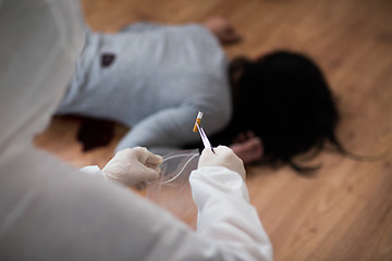 Image showing criminalist collecting crime scene evidence